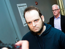 Joshua Boyle is escorted through the airport in Toronto after speaking to reporters on Friday, Oct. 13, 2017. 