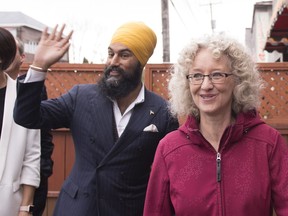 NDP Leader Jagmeet Singh, left, waves as he arrives for a news conference during a campaign visit for local candidate Gisele Dallaire, right, Tuesday, October 10, 2017 in Alma Quebec. THE CANADIAN PRESS/Jacques Boissinot