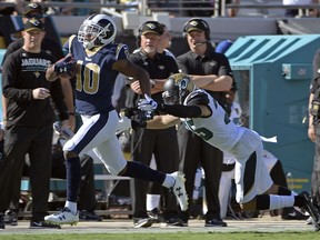 Los Angeles Rams' Pharoh Cooper, left, runs for a touchdown on a kickoff past Jacksonville Jaguars safety Peyton Thompson during the first half of an NFL football game, Sunday, Oct. 15, 2017, in Jacksonville, Fla. (AP Photo/Phelan M. Ebenhack)