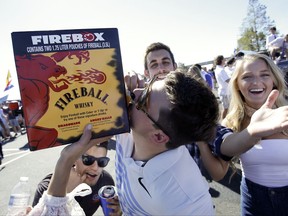 Fans drink whiskey in the parking lot before an NCAA college football game between Florida and Georgia, Saturday, Oct. 28, 2017, in Jacksonville, Fla. The annual SEC matchup is better known as "The World's Largest Outdoor Cocktail Party." (AP Photo/John Raoux)