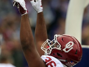 Oklahoma fullback Dimitri Flowers (36) celebrates a touchdown during the first half of an NCAA college football game against Kansas State in Manhattan, Kan., Saturday, Oct. 21, 2017. (AP Photo/Orlin Wagner)