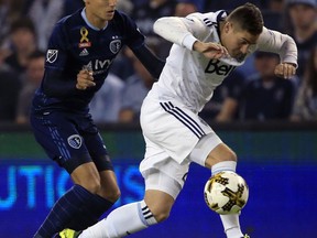 Vancouver Whitecaps defender Jake Nerwinski, right, gets away from Sporting Kansas City forward Daniel Salloi, left, during the first half of an MLS soccer match in Kansas City, Kan., Saturday, Sept. 30, 2017. (AP Photo/Orlin Wagner)