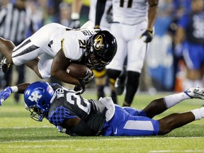 Missouri running back Ish Witter, top, is tackled by Kentucky safety Darius West during the first half of an NCAA college football game Saturday, Oct. 7, 2017, in Lexington, Ky. (AP Photo/David Stephenson)