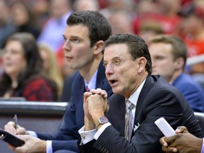 FILE - In this Dec. 7, 2016, file photo, Louisville men's basketball coach Rick Pitino, right, watches play while sitting next to assistant coach David Padgett during an NCAA college basketball game in Louisville, Ky. Padgett was named Louisville's interim coach Friday, Sept. 29, 2017. (AP Photo/Timothy D. Easley, File)