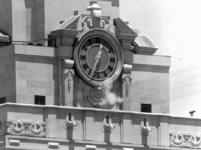 FILE - In this Aug. 1, 1966, file photo, smoke rises from the sniper's gun as he fired from the tower of the University of Texas administration building in Austin, Texas, on crowds below. Charles Whitman, a 25-year-old architectural engineering major and ex-Marine, killed his wife, his mother and three others before climbing the 27 stories of a tower at the University of Texas and raining gunfire on the plaza below. Over 96 minutes, another 11 people were killed and 31 injured before Whitman was killed by police officers. (AP Photo/File)