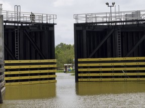 The Caernarvon floodgate closes in St. Bernard Parish before the arrival of Tropical Storm Nate in Caernarvon, La., Friday, Oct. 6, 2017. Many fisherman and crab trappers were allowed to dock their boats inside the floodgate at the St. Bernard Parish line before 1 p.m., Friday. (Matthew Hinton/The Advocate via AP)