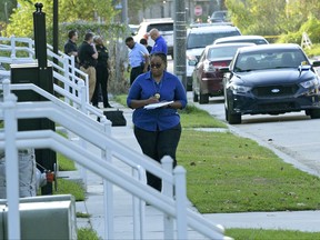 New Orleans Police investigators record the scene where an officer was shot and killed after exchanging fire with a suspect at the Cypress Parc Apartments in New Orleans, Friday, Oct. 13, 2017. (Max Becherer /The Advocate via AP)
