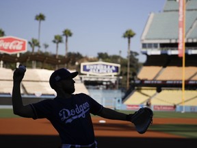 Los Angeles Dodgers bullpen catcher Steve Cilladi throws during batting practice before Game 1 of the baseball team's National League Division Series against the Arizona Diamondbacks in Los Angeles, Friday, Oct. 6, 2017. (AP Photo/Jae C. Hong)