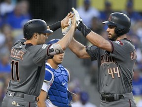 Arizona Diamondbacks' Paul Goldschmidt, right, celebrates his two-run home run with A.J. Pollock against the Los Angeles Dodgers during the first inning of Game 2 of baseball's National League Division Series in Los Angeles, Saturday, Oct. 7, 2017. (AP Photo/Mark J. Terrill)