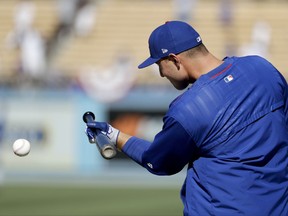 Chicago Cubs first baseman Anthony Rizzo warms up during batting practice before Game 2 of baseball's National League Championship Series against the Los Angeles Dodgers in Los Angeles, Sunday, Oct. 15, 2017.(AP Photo/Matt Slocum)