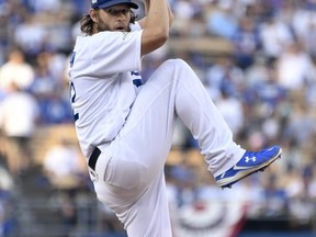 Los Angeles Dodgers starting pitcher Clayton Kershaw winds up during the first inning of Game 1 against the Chicago Cubs in baseball's National League Championship Series in Los Angeles, Saturday, Oct. 14, 2017.  (Wally Skalij/Los Angeles Times via AP, Pool)