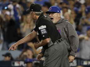 Chicago Cubs manager Joe Maddon, right, is thrown out by umpire Mike Winters during the seventh inning of Game 1 of baseball's National League Championship Series against the Los Angeles Dodgers in Los Angeles, Saturday, Oct. 14, 2017. (AP Photo/Matt Slocum)
