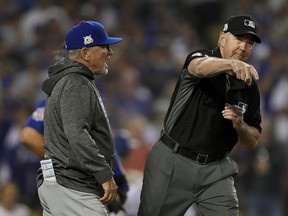 Chicago Cubs manager Joe Maddon, left, is thrown out of the game by umpire Mike Winters, during the seventh inning against the Los Angeles Dodgers in Game 1 of baseball's National League Championship Series in Los Angeles, Saturday, Oct. 14, 2017. (AP Photo/Mark J. Terrill)