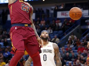 Cleveland Cavaliers forward LeBron James (23) slam dunks in front of New Orleans Pelicans forward DeMarcus Cousins (0) in the first half of an NBA basketball game in New Orleans, Saturday, Oct. 28, 2017. (AP Photo/Gerald Herbert)