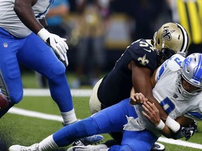 Detroit Lions quarterback Matthew Stafford (9) fumbles as he is hit by New Orleans Saints defensive end Alex Okafor (57), causing a touchdown on the fumble recovery in the end zone, in the first half of an NFL football game in New Orleans, Sunday, Oct. 15, 2017. (AP Photo/Butch Dill)