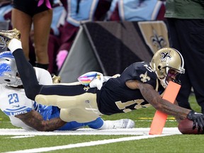 New Orleans Saints wide receiver Ted Ginn (19) breaks past Detroit Lions cornerback Darius Slay on a touchdown reception in the first half of an NFL football game in New Orleans, Sunday, Oct. 15, 2017. (AP Photo/Bill Feig)