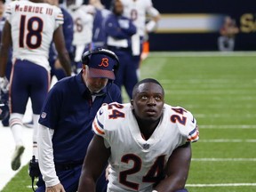 Chicago Bears running back Jordan Howard (24) and head coach John Fox, behind, kneel in sympathy for injured Bears tight end Zach Miller, in the second half of an NFL football game against the New Orleans Saints in New Orleans, Sunday, Oct. 29, 2017. Miller hurt his leg on an apparent touchdown reception that was overturned on review. (AP Photo/Butch Dill)