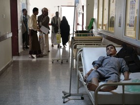 FILE - In this photo from files taken on Thursday, June. 29, 2017, a man is treated for a suspected cholera infection at a hospital in Sanaa, Yemen. The World Health Organization's emergencies chief, Dr. David Salama, said Tuesday, Oct. 3, 2017 that the agency could have acted faster and sent more vaccines to fight a massive, deadly surge of cholera cases in war-battered Yemen this year. (AP Photo/Hani Mohammed, File)