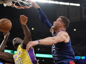 Los Angeles Clippers forward Blake Griffin, right, dunks on Los Angeles Lakers forward Julius Randle during the first half of an NBA basketball game, Thursday, Oct. 19, 2017, in Los Angeles. (AP Photo/Mark J. Terrill)