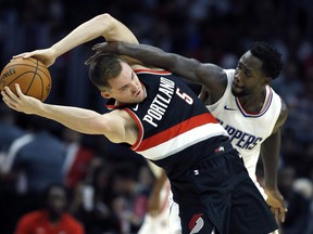 Los Angeles Clippers guard Patrick Beverley, right, competes for the ball held by Portland Trail Blazers guard Pat Connaughton, but is called for a foul during the first half of a preseason NBA basketball game in Los Angeles, Sunday, Oct. 8, 2017. (AP Photo/Alex Gallardo)