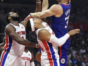 Los Angeles Clippers forward Blake Griffin, right, shoots as Detroit Pistons center Andre Drummond, left, and forward Tobias Harris defend during the first half of an NBA basketball game, Saturday, Oct. 28, 2017, in Los Angeles. (AP Photo/Mark J. Terrill)