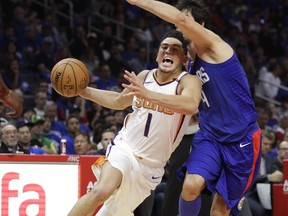 Los Angeles Clippers' Milos Teodosic, right, defends Phoenix Suns' Devin Booker during the first half of an NBA basketball game Saturday, Oct. 21, 2017, in Los Angeles. (AP Photo/Jae C. Hong)
