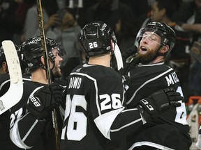 Los Angeles Kings defenseman Jake Muzzin, right, is congratulated after scoring the winning goal in overtime to beat the Anaheim Ducks 1-0 during a preseason NHL hockey game, Saturday, Sept. 30, 2017, in Los Angeles. (AP Photo/Michael Owen Baker)