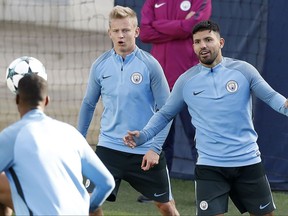 Manchester City's Sergio Aguero, left, attends a training session with his teammates at the City Football Academy, Manchester, England, Monday Oct. 16, 2017. (Martin Rickett/PA via AP)