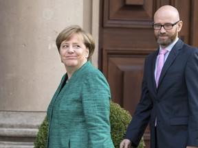 German Chancellor Angela Merkel and and Secretary General of her party the Christian Union, CDU, Peter Tauber arrive for exploratory talks between CDU and the Free Democratic party, FDP, three weeks after election, in Berlin, Germany, Wednesday, Oct. 18, 2017. (Bernd Von Jutrczenka/dpa via AP)