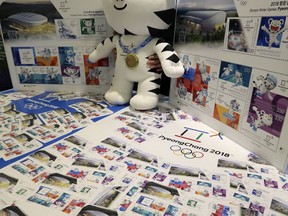 An official mascot of the 2018 Pyeongchang Olympic Winter Games, white tiger "Soohorang," is shown with sheets of commemorative stamps for the Pyeongchang 2018 Winter Olympics at Korea Postage Stamp Museum in Seoul, South Korea, Tuesday, Oct. 31, 2017. South Korea's Pyeongchang is the host city of the 2018 Winter Olympics which will be held from February 9 to February 25. (AP Photo/Lee Jin-man)