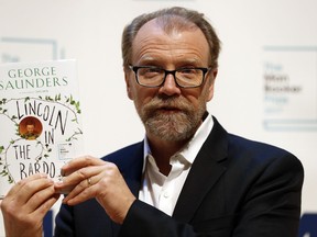 Author George Saunders of the United States with his book 'Lincoln in the Bardo' during a photocall with all six shortlisted authors of the 2017 Man Booker Prize for Fiction, in London, Monday, Oct. 16, 2017. The winner of the award will be announced Tuesday at a ceremony in London. (AP Photo/Kirsty Wigglesworth)