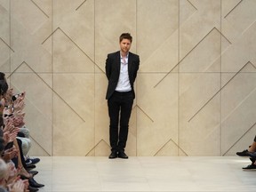 FILE - In this Saturday, June 23, 2012, file photo, British fashion designer Christopher Bailey receives applause from the audience after presenting Burberry Prorsum, from the men's Spring-Summer 2013 collection, part of the Milan Fashion Week, in Milan, Italy. Burberry's chief creative officer and president will be leaving the company by the end of 2018. The luxury retailer said Tuesday, Oct. 31, 2017 that Christopher Bailey has decided it was time to "pursue new creative projects." (AP Photo/Luca Bruno, file)