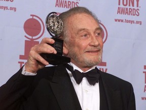 FILE - In this file photo dated Sunday, June 4, 2000, Roy Dotrice poses with his Tony award for Best Featured Actor in a Play for his work in "A Moon For The Misbegotten," at the 54th annual Tony Awards ceremony in New York.  The family of veteran British actor Roy Dotrice said Monday Oct. 16, 2017, that he has died aged 94, in his London home. (AP Photo/Richard Drew, FILE)