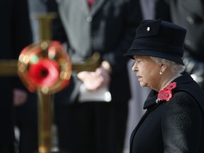 FILE - A Sunday, Nov. 13, 2016 file photo of Britain's Queen Elizabeth II taking part in the Remembrance Sunday service at the Cenotaph in London. Queen Elizabeth II will not personally place a wreath on The Cenotaph on Remembrance Sunday this year. The aging monarch and her husband Prince Philip will instead watch the ceremony from a balcony at the Foreign & Commonwealth Office. (AP Photo/Alastair Grant, File)