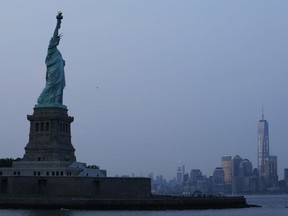 FILE - In this Tuesday, July 7, 2015, file photo, the Statue of Liberty stands in New York harbor with the New York City skyline in the background. UNESCO is known for proclaiming World Heritage sites _ places like the Egyptian pyramids or the Statue of Liberty that are conferred a special U.N. status. (AP Photo/Kathy Willens, File)