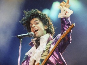 FILE - In this Feb. 18, 1985 file photo, Prince performs at the Forum in Inglewood, Calif. A pair of floral-patterned satin shoes worn by Prince has stepped into the collection of Britain's Victoria & Albert Museum. (AP Photo/Liu Heung Shing, File)
