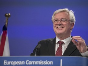 FILE -  A Thursday, Sept. 28, 2017 file photo of British Secretary of State for Exiting the European Union, David Davis, addressing a media conference at EU headquarters in Brussels. Britain's Brexit minister says he expects negotiations with the European Union won't end until the last moment before the U.K. officially leaves the bloc in March 2019. (AP Photo/Olivier Matthys, File)