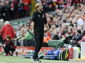 FILE - In this file photo dated Saturday, Oct. 14, 2017, Liverpool coach Juergen Klopp reacts on the sidelines during the English Premier League soccer match between Liverpool and Manchester United at Anfield, Liverpool, England.   Klopp and Huddersfield manager David Wagner are best friends off the field, but will be rival managers when Liverpool face off against Huddersfield on upcoming Saturday Oct. 28, 2017. (AP Photo/Rui Vieira, FILE)