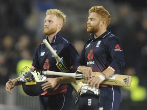 FILE- In this Tuesday, Sept. 19, 2017 file photo, England's Johnny Bairstow, right, and England's Ben Stokes leave the pitch after England beat the West Indies by seven wickets during the first One Day International match between England and West Indies at Old Trafford in Manchester, England. England cricketers Jonny Bairstow, Jake Ball and Liam Plunkett have been punished for off-field misbehavior.  (AP Photo/Rui Vieira, File)