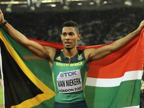 FILE - In this Thursday, Aug. 10, 2017 file photo, South Africa's Wayde van Niekerk celebrates after taking the silver medal in the Men's 200m final during the World Athletics Championships in London. Wayde van Niekerk will be out for 6-9 months and was due to have surgery in the United States on Tuesday Oct. 31, 2017 after tearing a ligament and cartilage in his right knee during a celebrity tag rugby game. (AP Photo/Tim Ireland, File)