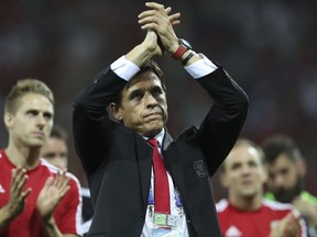 FILE - In this Wednesday, July 6, 2016 file photo, Wales coach Chris Coleman acknowledges the fans at the end of their Euro 2016 semifinal soccer match against Portugal at the Grand Stade in Decines-­Charpieu, France. Five straight draws in qualifying for the 2018 World Cup, including one at home to Georgia, left the Welsh fearing they'd be watching the tournament on TV. With no margin for error, Wales has steadied the campaign with wins over Austria and Moldova but Bale and his teammates have a defining week ahead of them: Georgia away on Friday, Oct. 6, 2017 and then a group-ending home match against Ireland on Monday. "Realistically," Wales coach Chris Coleman has said, "we have to get maximum (points) to give ourselves a chance of second." (AP Photo/Thanassis Stavrakis, file)
