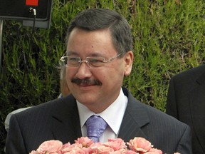 FILE - In this Thursday, June 15, 2006 file photo, Ankara Mayor Melih Gokcek poses with a bouquet of French rose named " Boticelli" in the garden of French embassy in Ankara. The mayor of Turkey's capital says he is resigning, apparently succumbing to weeks of pressure from President Recep Tayyip Erdogan. Ankara Mayor Melih Gokcek announced after a meeting with Erdogan on Monday, Oct. 23, 2017 that he would step down Saturday. Gokcek is the fifth elected mayor from Erdogan's party to leave office under pressure from the president. (AP Photo, file)