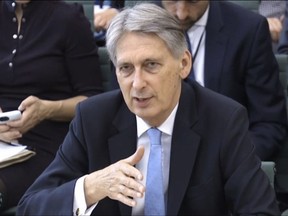 Britain's Chancellor of the Exchequer Philip Hammond answers questions at the parliamentary Commons Treasury Select Committee in  London on Wednesday Oct. 11, 2017.  Hammond said a worst-case Brexit scenario could see all air traffic between the U.K. and the European Union grounded the day after Britain leaves the bloc on March 29, 2019. Philip Hammond was answering lawmakers' questions Wednesday about government planning for the possibility divorce talks could end without a deal on trade, security and other relations.(PA via AP)