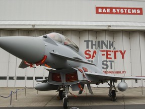 FILE - This is a  Sept. 7, 2012 file photo of a Eurofighter Typhoon at BAE Systems, Warton Aerodrome, near Warton northwest England. British defense company BAE Systems is cutting almost 2,000 jobs in its military, maritime and intelligence services in an effort to boost competitiveness. CEO Charles Woodburn said in a statement Tuesday Oct. 10, 2017, that the actions are necessary to "align our workforce capacity more closely with near-term demand and enhance our competitive position to secure new business." (Peter Byrne/PA, File via AP)