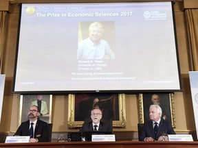 Per Stromberg, Chairman of the Committee, left, Goran K Hansson, Secretary of the Committee, centre, and Peter Gardenfors, Member of the Committee, announce Richard Thaler of the University of Chicago, as the  the 2017 Nobel  Economics Prize winner  in Stockholm,  Monday Oct. 9, 2017. (Henrik Montgomery/TT via AP)