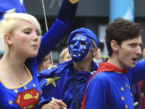Demonstrators dressed as super-heroes during a Stop Brexit march making its way towards the Conservative party conference being held at the Manchester Central Convention Complex in Manchester, England, Sunday Oct. 1, 2017.  The ruling Conservative Party is holding its annual conference with Prime Minister Theresa May facing fresh party tensions over how to manage Britain's Brexit departure from the European Union. (Peter Byrne/PA via AP)