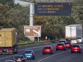 An overhead road sign on the M2 motorway near Belfast, Northern Ireland warns drivers of, "Strong Winds Forecast Today", as the remnants of  Hurricane Ophelia begins to hit Ireland and parts of Britain. Ireland's meteorological service is predicting wind gusts of 120 kph to 150 kph (75 mph to 93 mph), sparking fears of travel chaos. Some flights have been cancelled, and aviation officials are warning travelers to check the latest information before going to the airport Monday.  (Liam McBurney/PA via AP)