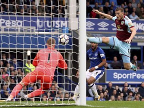Everton goalkeeper Jordan Pickford in action as Burnley's Chris Wood tries to make a shot, during their English Premier League soccer match at Goodison Park in Liverpool, England, Sunday Oct. 1, 2017.  (Martin Rickett/PA via AP)