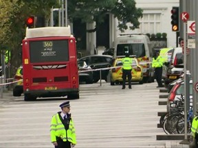 In this image taken from TV, police officers surround the scene of an incident involving a car, at center, in central London, Saturday, Oct. 7, 2017. British emergency services raced to London's Natural History Museum after a car struck pedestrians Saturday outside the building. Police said a number of people were injured and one person was detained at the scene. (AP Photo)