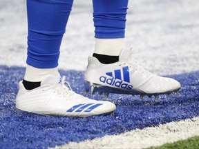 FILE- In this Sunday, Sept. 10, 2017 file photo, Detroit Lions running back Ameer Abdullah wears adidas cleats before an NFL football game against the Arizona Cardinals in Detroit. Multi-million dollar sponsor partnerships between sports equipment companies and U.S. university athletic programs _ like the one between Adidas and the University of Louisville _ are a key weapon in the battle for sales and profits in the world's largest economy. (AP Photo/Paul Sancya, File)